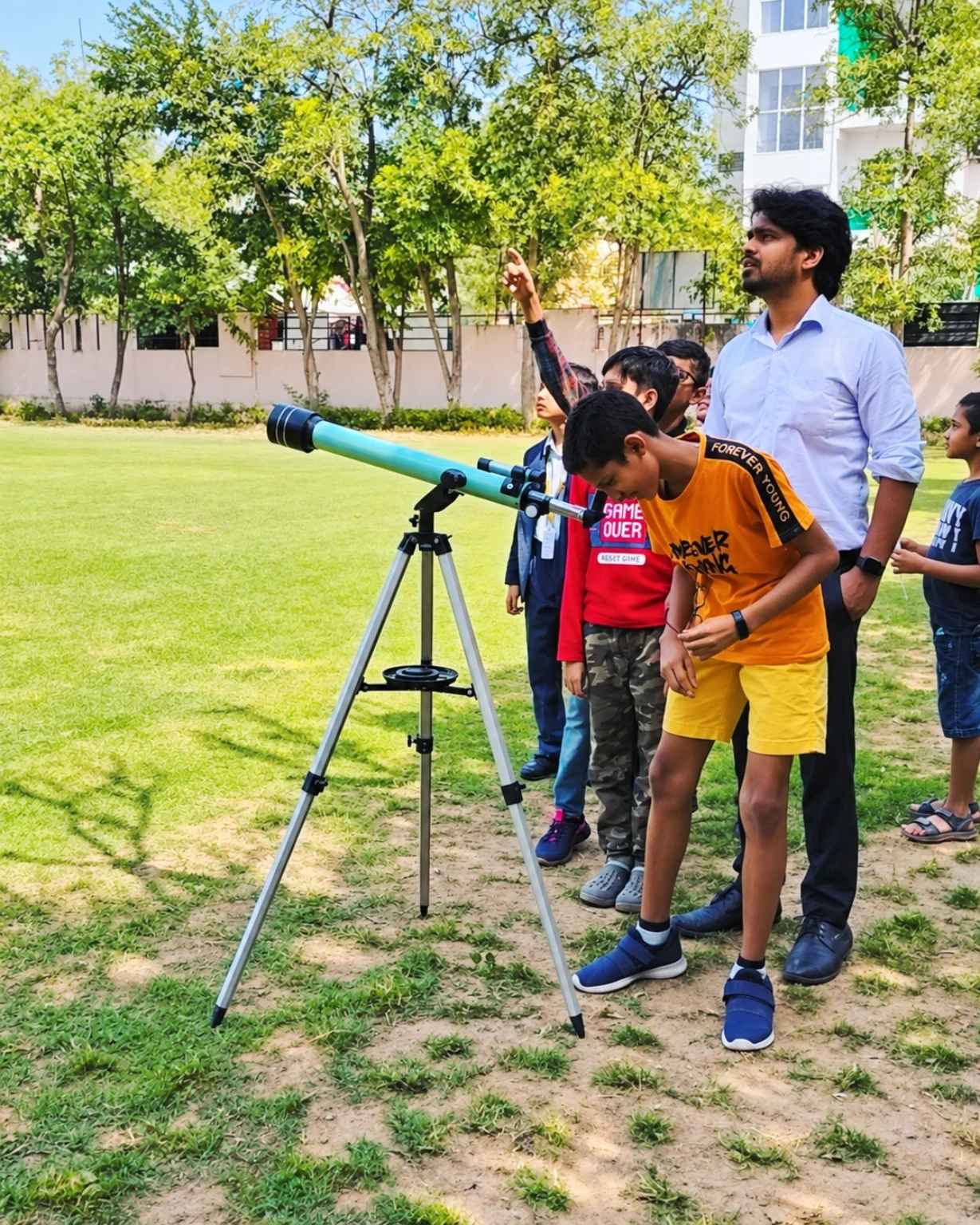 Students exploring a telescope during a Foundation science activity
